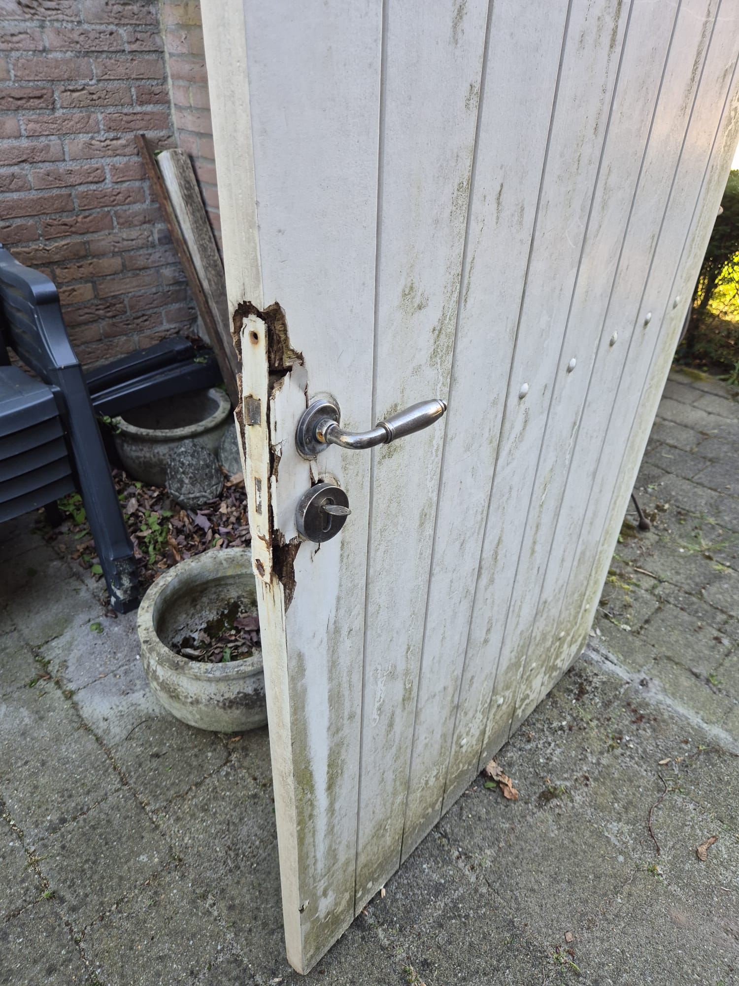 Houtrot rond het slot van een tuinpoort voor het herstel